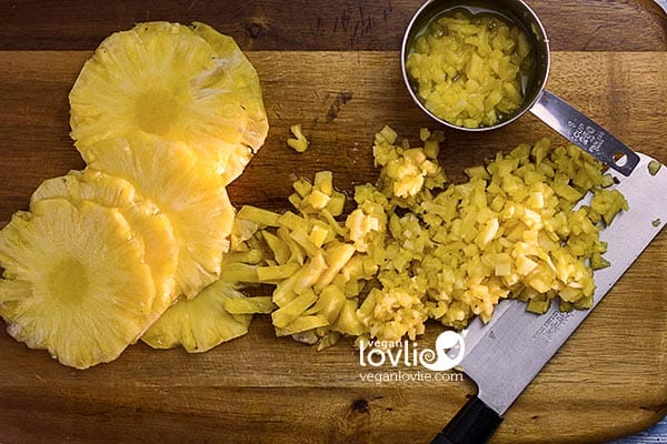 Slices and minced fresh pineapple on chopping board