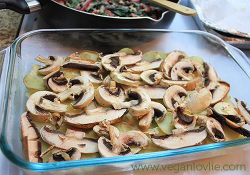 Vegan gratin - layer mushrooms on potatoes