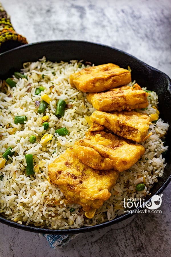 Crispy battered turmeric tofu served with soy sauce and fried rice